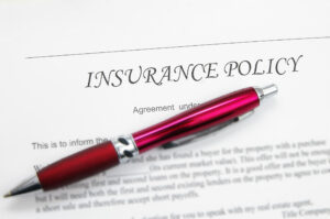 Subrogation-insurance policy paper with red pen on top.